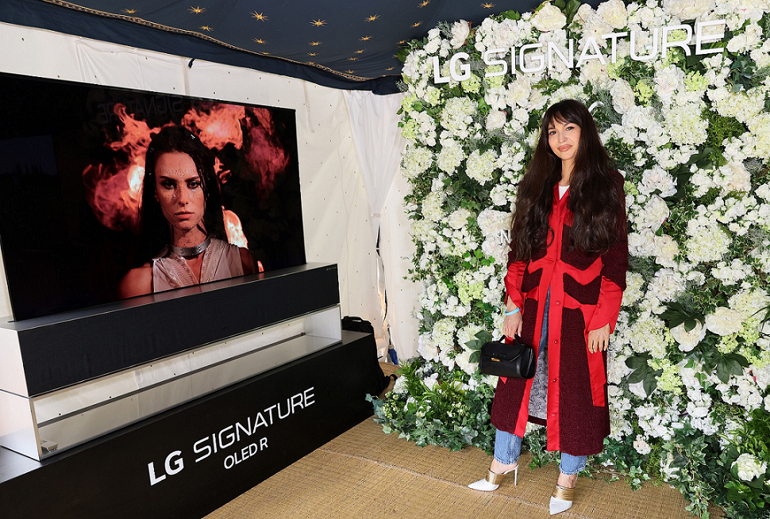 British presenter and DJ Zara Martin posing in front of LG SIGNATURE OLED R.